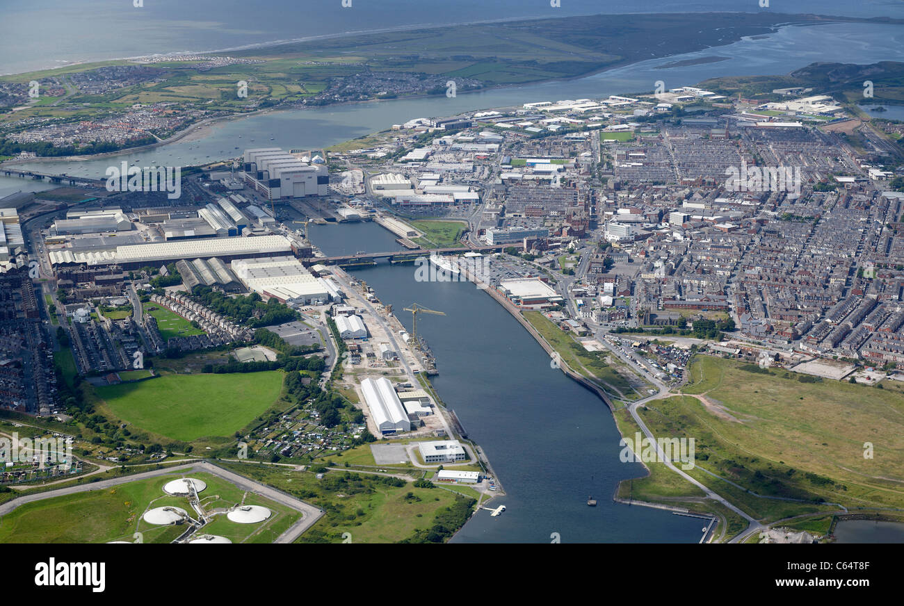 Barrow Docks and Ship Production Facility,  Barrow in Furness, North West England, with Walney Island behind Stock Photo