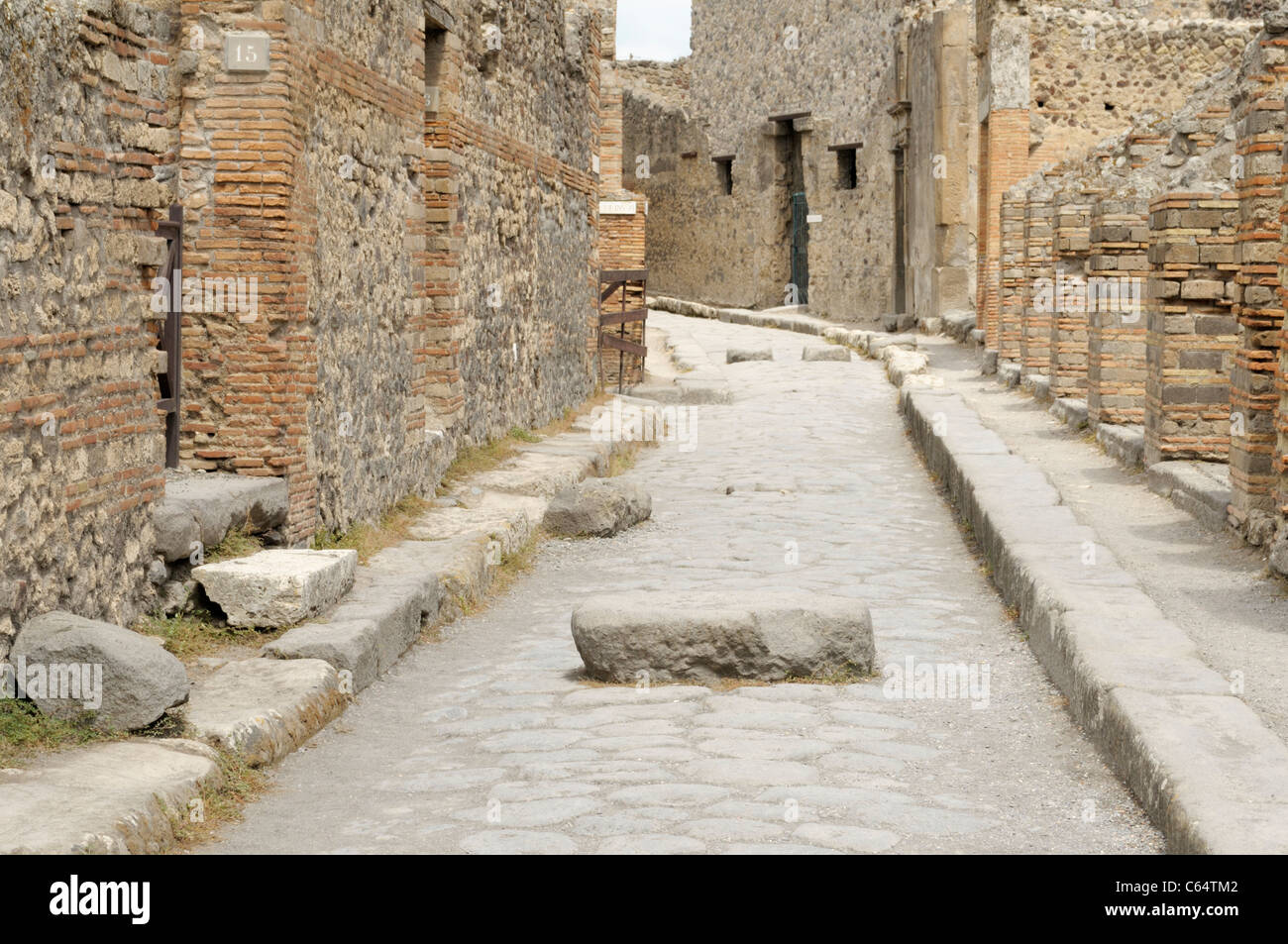 Pompeii ancient street, with block for stepping across Stock Photo