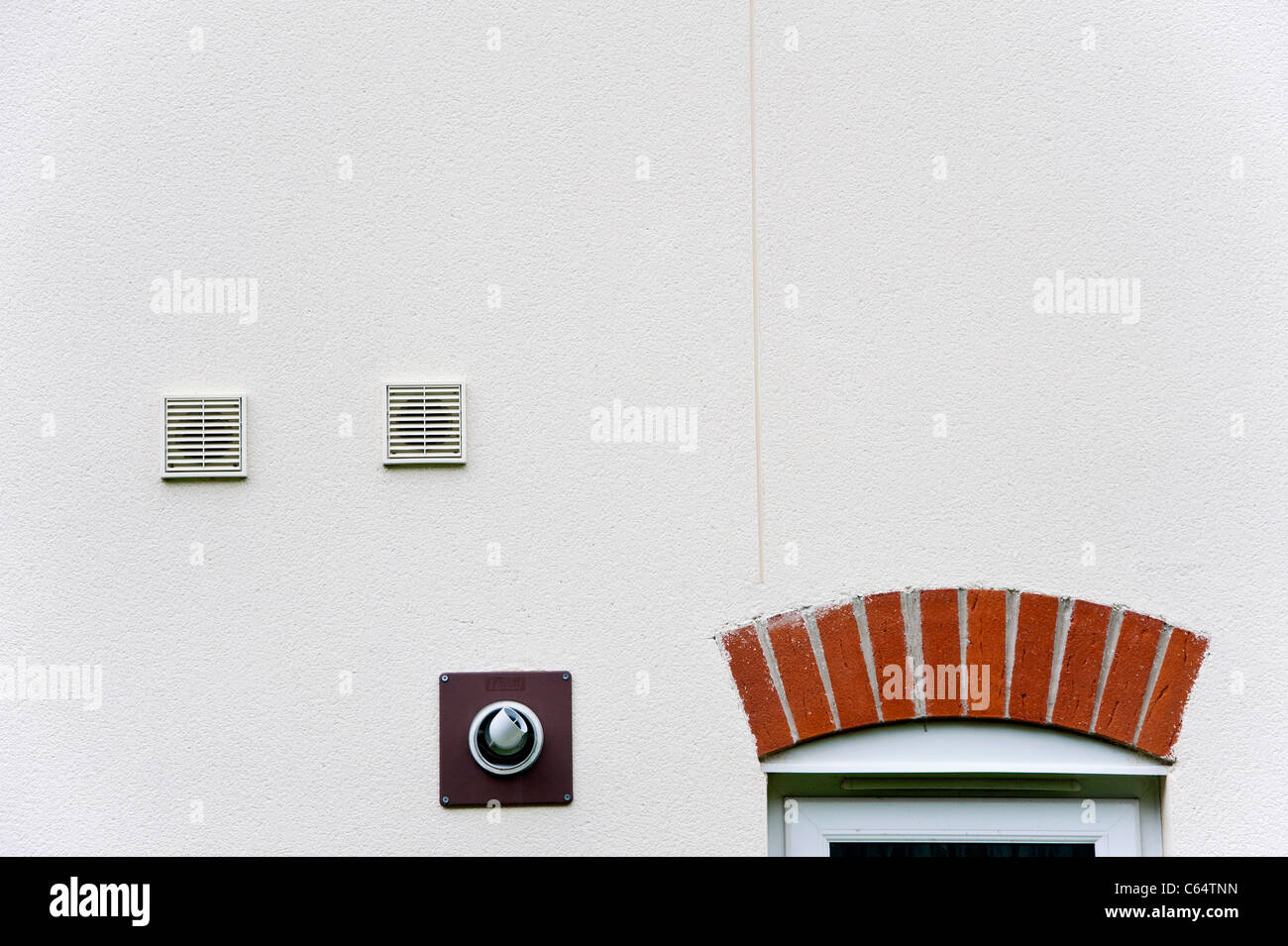 Wallmounted ventilation outlets and the flue from a gas boiler, on the