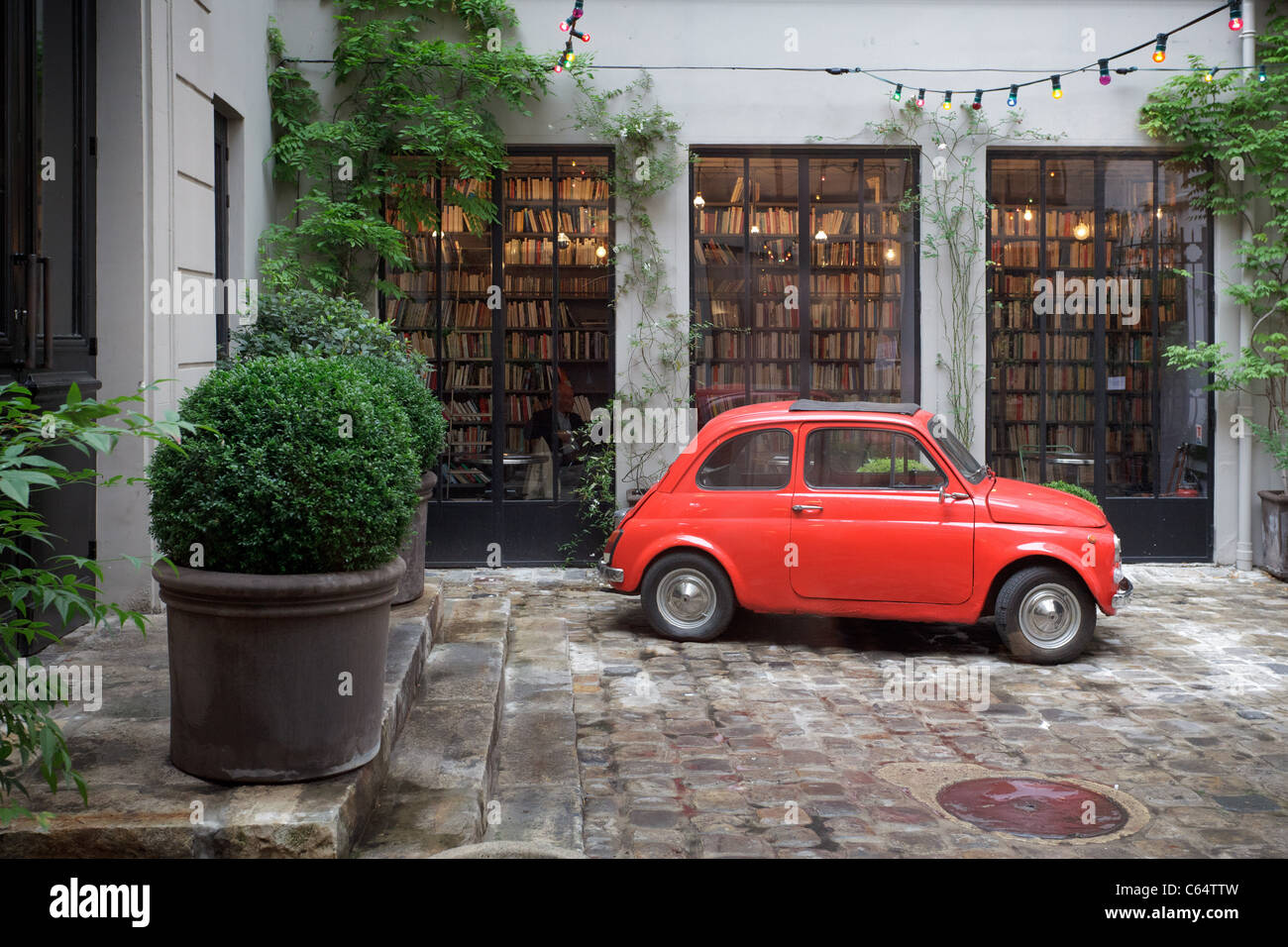 Red Fiat 500 car in courtyard outside Paris concept store, Merci Stock Photo