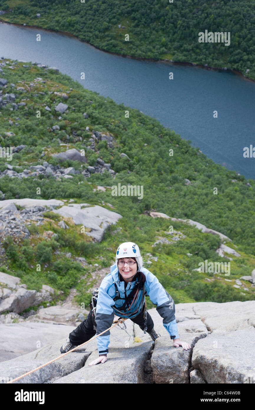 A Happy Female Climber Climbing In Lofoten Islands Norway Stock Photo