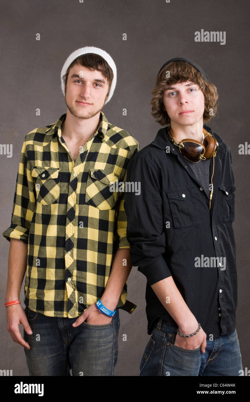 Two young men, friends, pose for a studio photographic portrait Stock Photo
