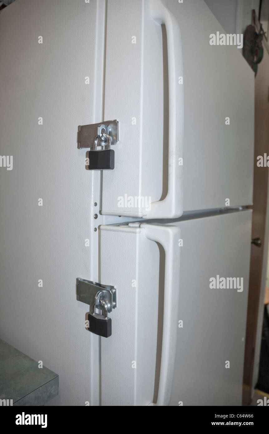 locks on a refrigerator door to keep someone on their diet Stock