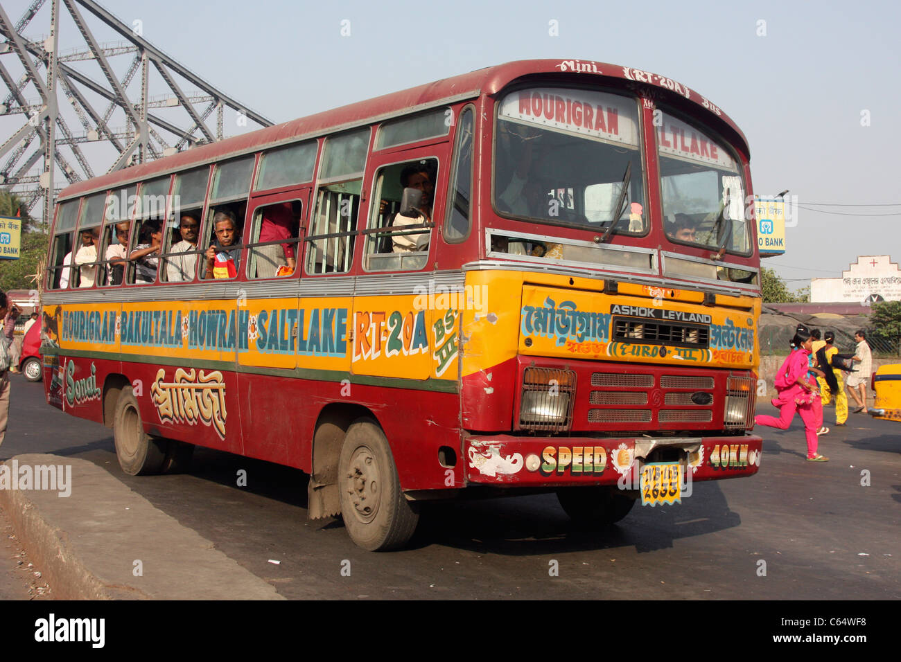 Passengers run to catch local bus near Howrah bridge Kolkata India ...