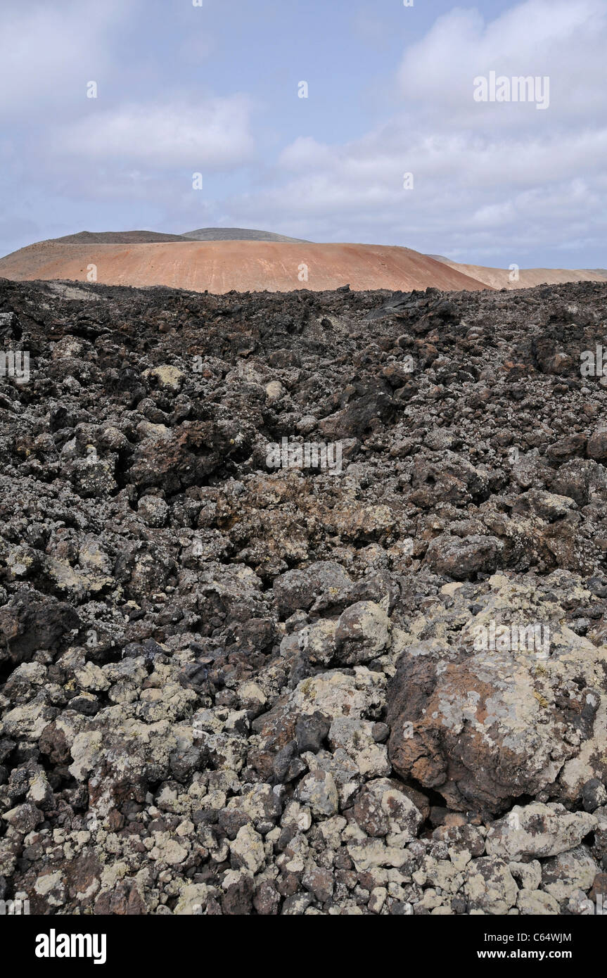 Lava field, with lichens, and volcanic cone, Timanfaya National Park, Lanzarote, Canary Islands, Spain Stock Photo