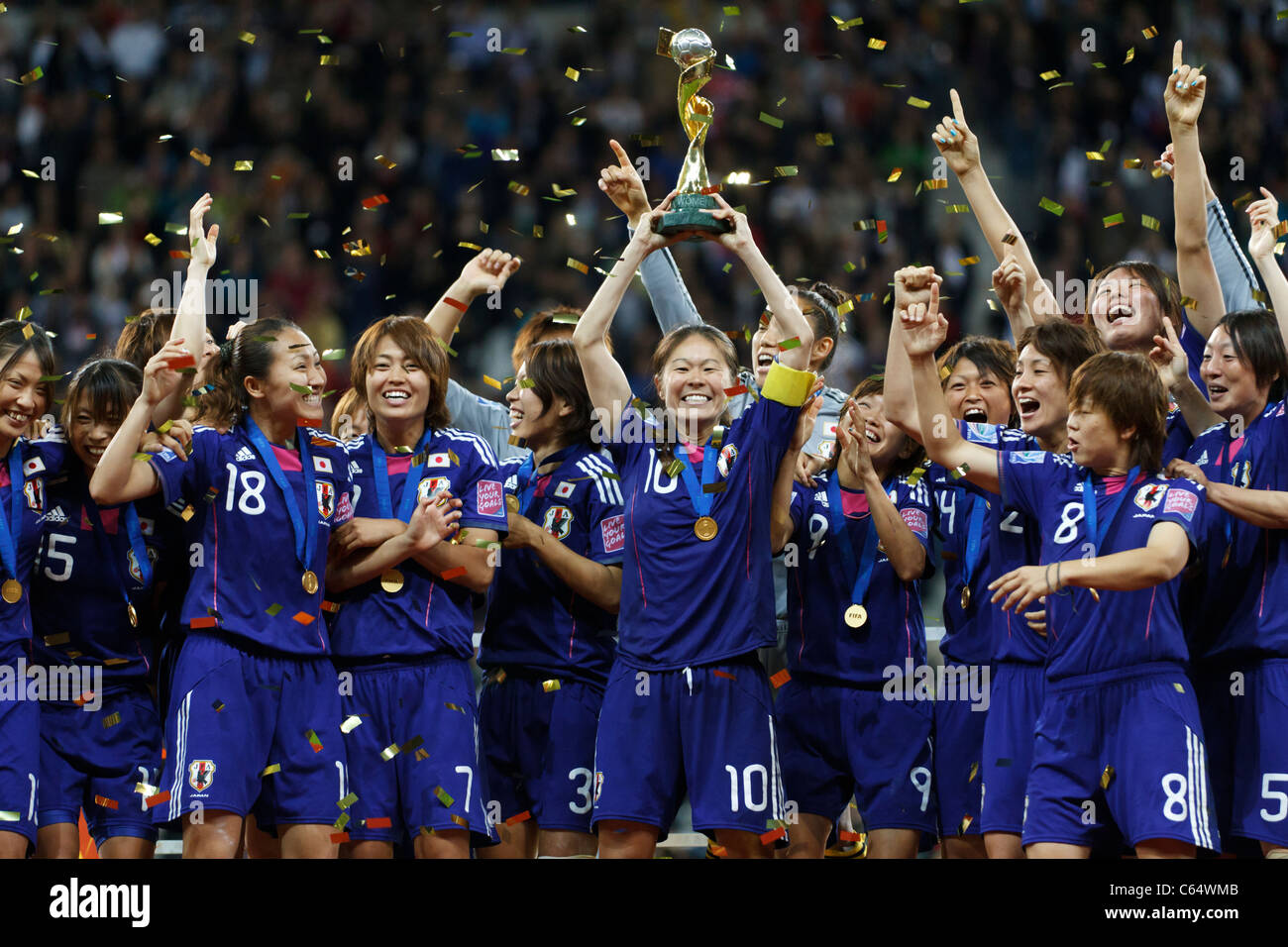 Japan captain Homare Sawa holds the World Cup trophy and celebrates with teammates after defeating the USA in the 2011 final. Stock Photo