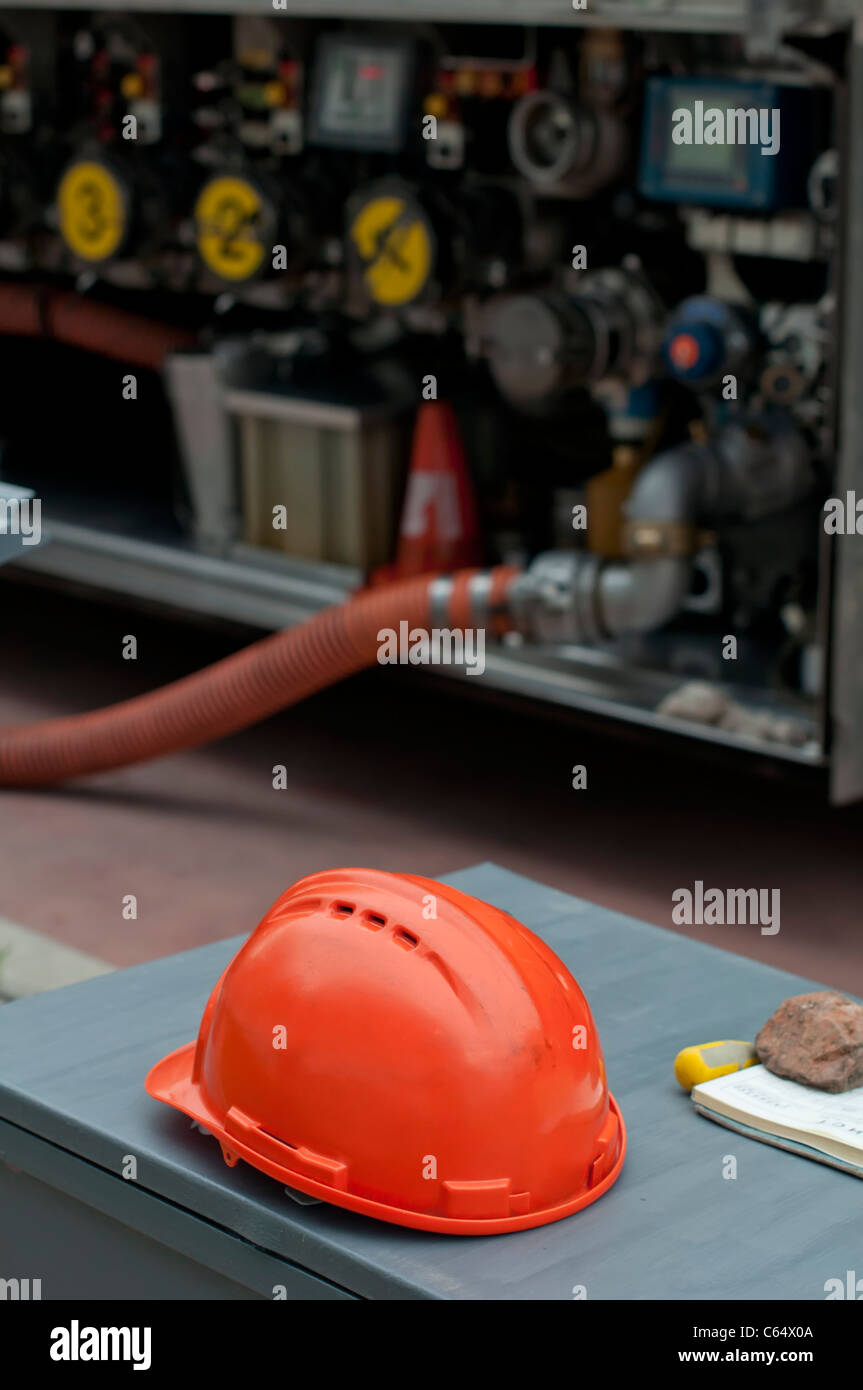 Fuel truck and red helmet close up Stock Photo