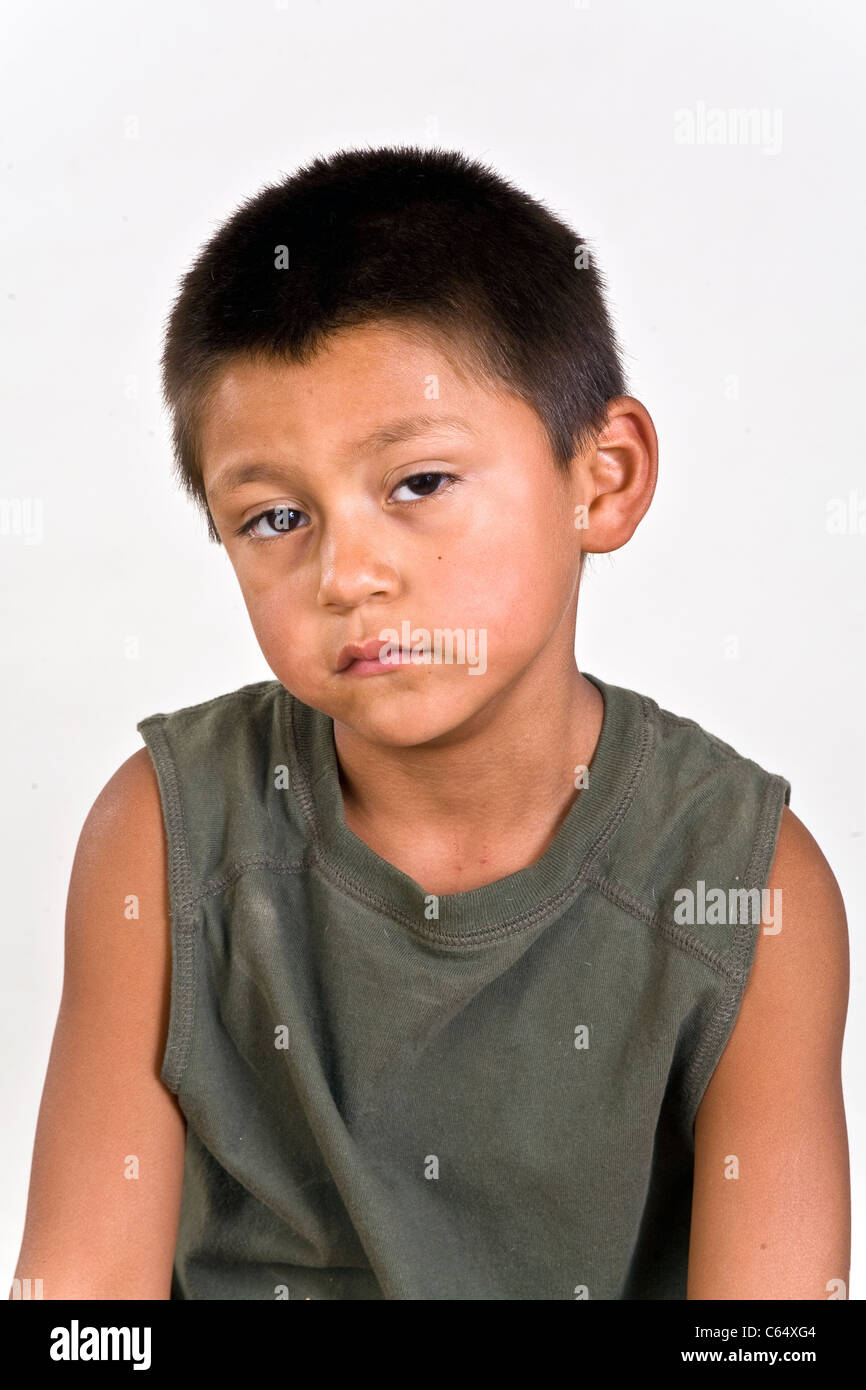 Young 6-7 years old Hispanic boy with sad pitiful expression on his face. MR © Myrleen Pearson Stock Photo