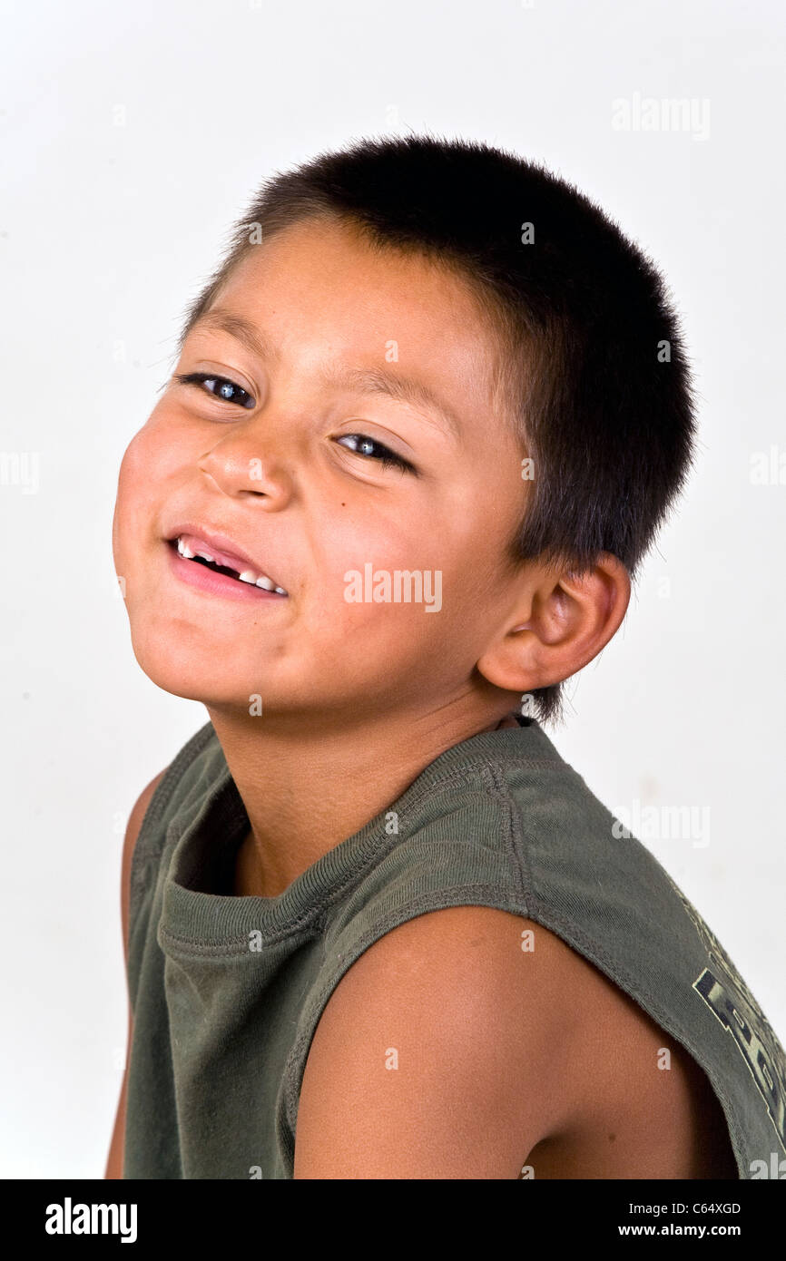 Cute sweet  young 6-7 year old Hispanic boy with two missing front teeth. MR © Myrleen Pearson Stock Photo