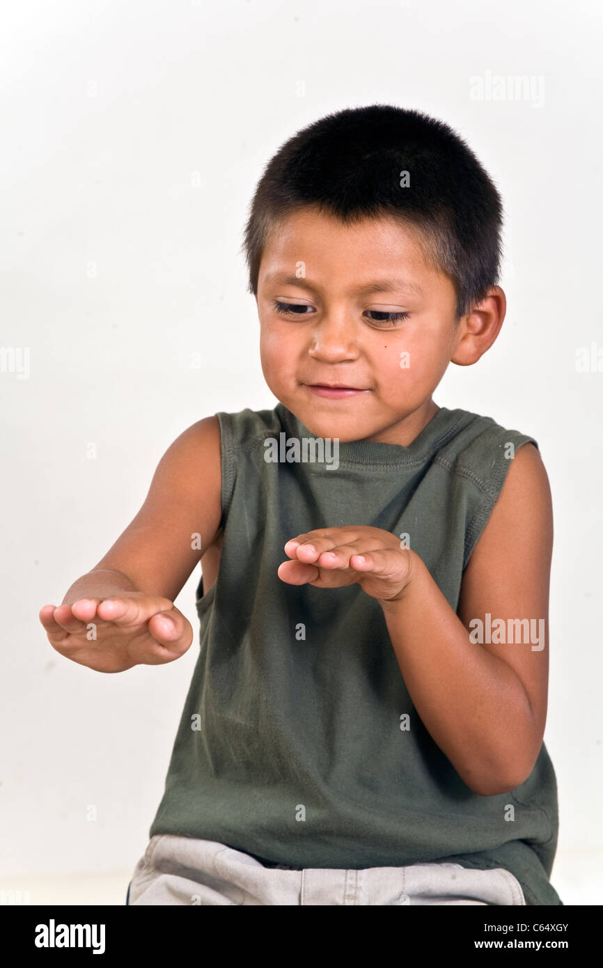 imaginative child using hands to express his imagination 6-7 year old Hispanic boy. MR © Myrleen Pearson Stock Photo