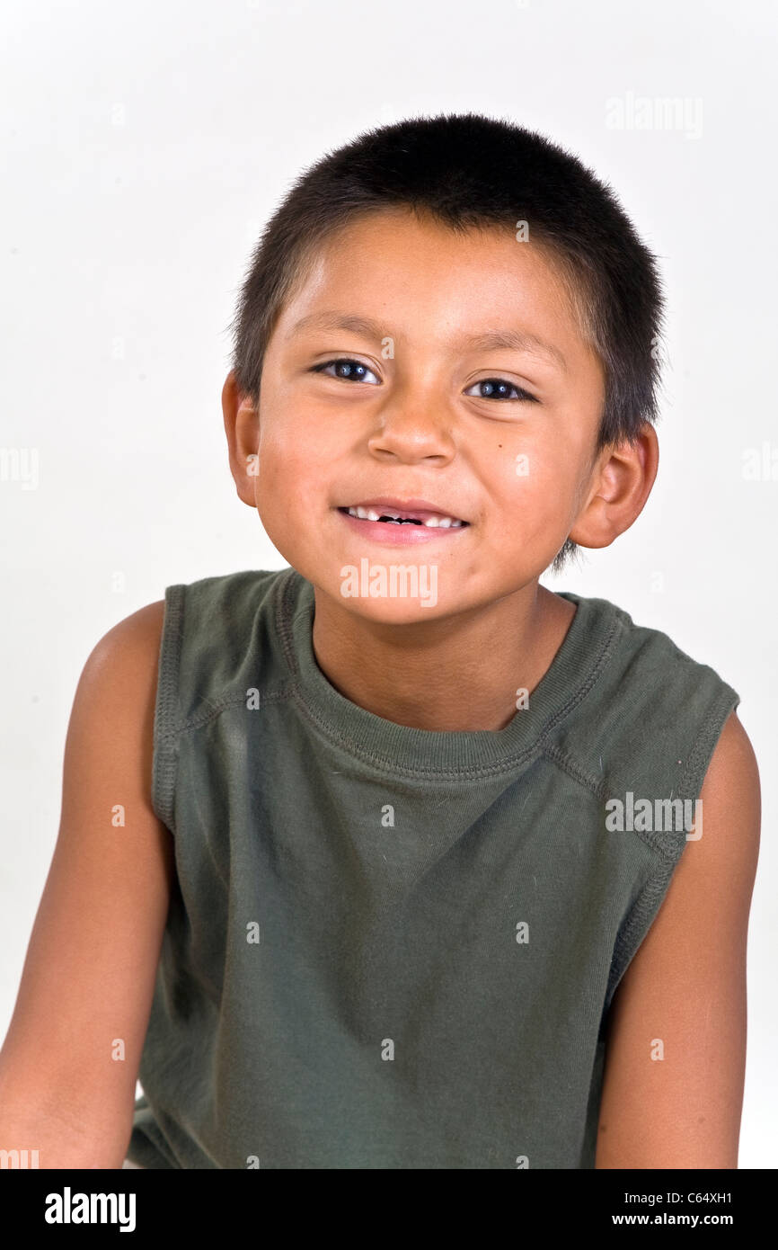 Happy 6-7 year old Hispanic boy with missing two front teeth. MR © Myrleen Pearson Stock Photo