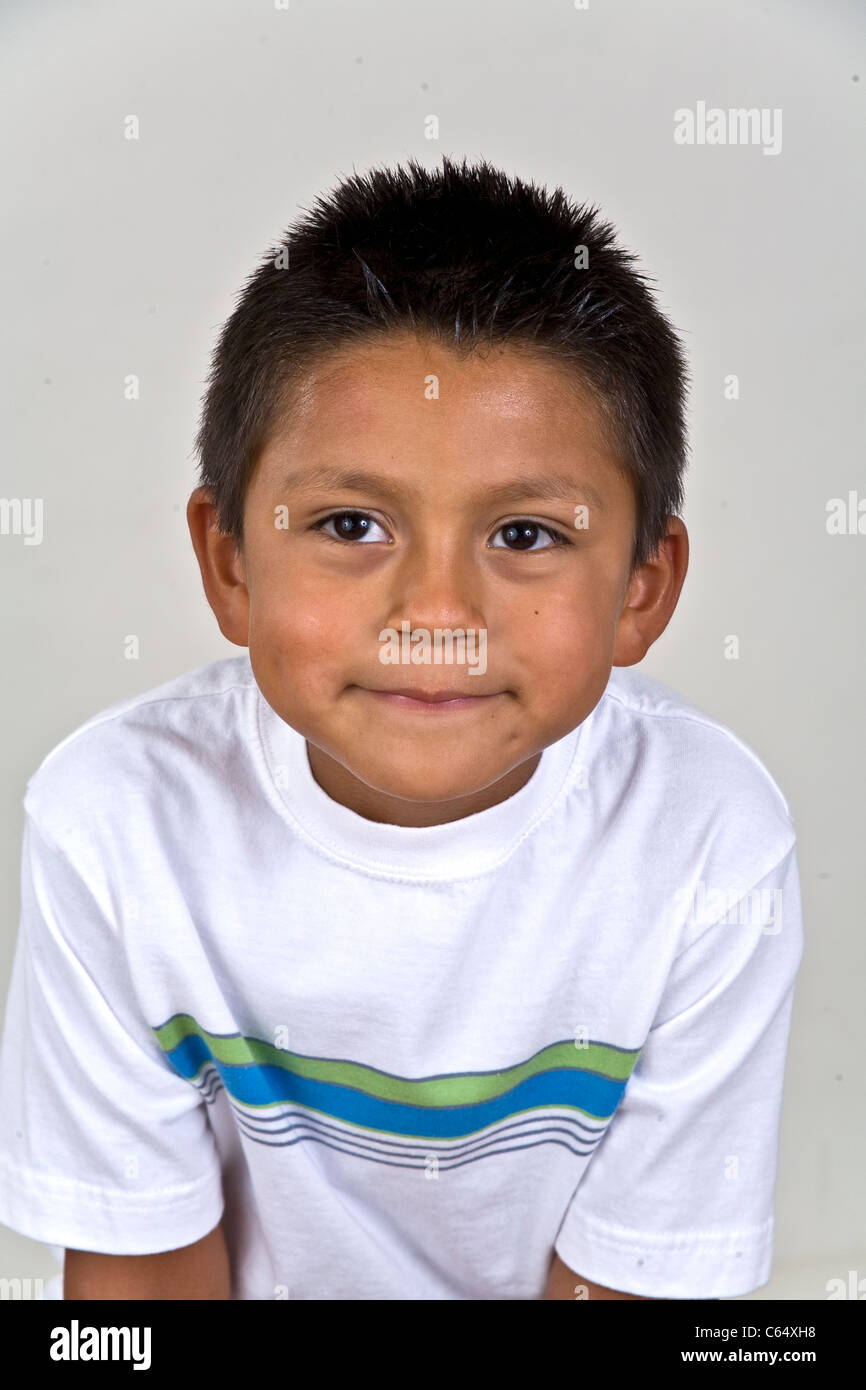 Young 6-7 year old Hispanic boy grinning mischievous mischief thoughts. MR © Myrleen Pearson Stock Photo