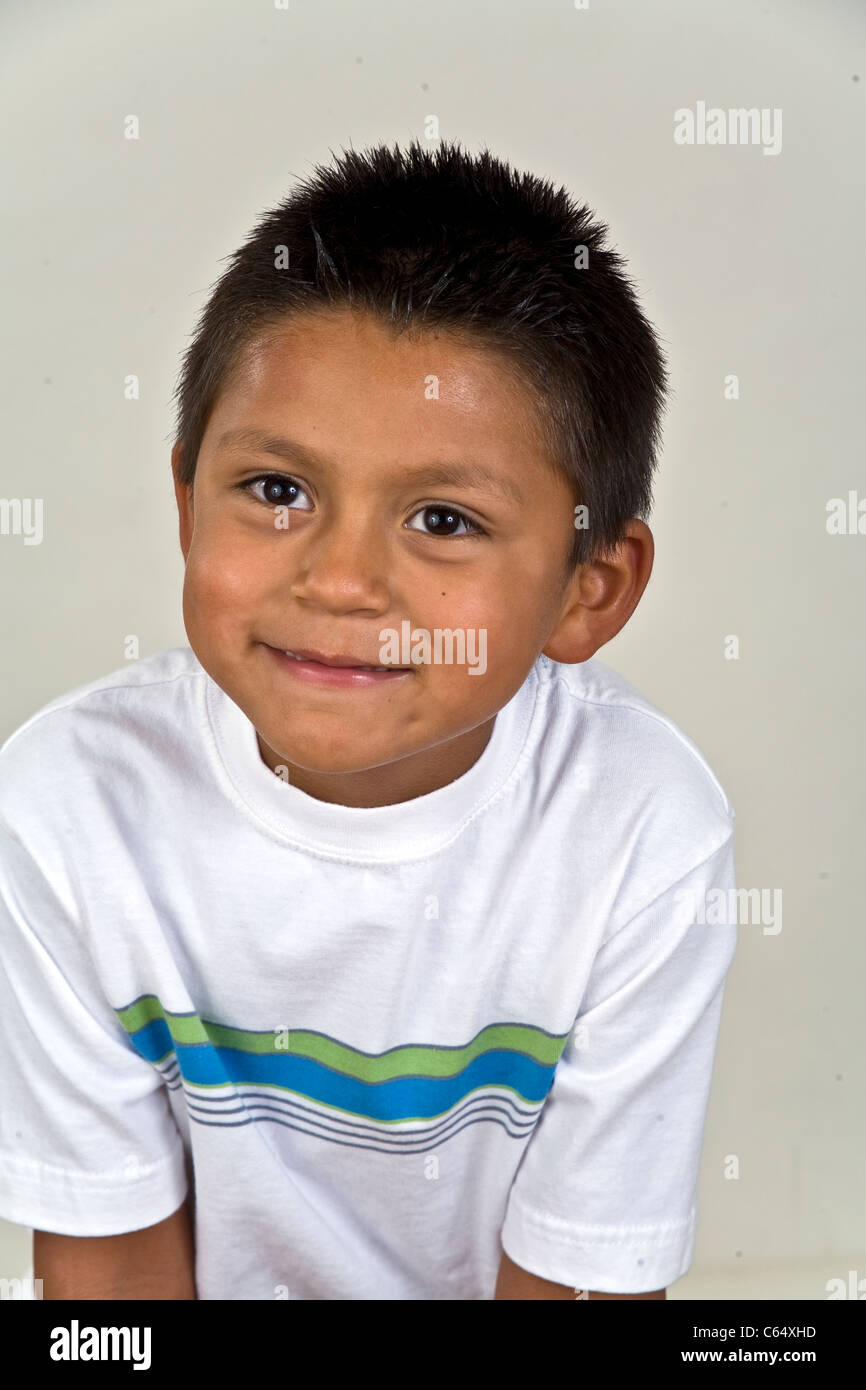 Young 6-7 year years old Hispanic boy multi ethnic inter racial diversity racially diverse multicultural multi cultural interracial. MR Stock Photo
