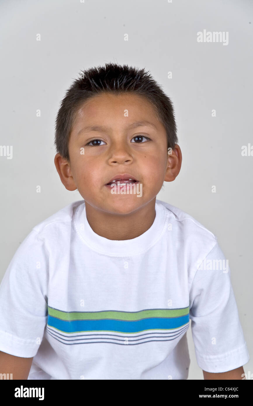 6-7 year years old Hispanic boy with two missing front teeth.thoughtful dreaming sitting  MR © Myrleen Pearson Stock Photo
