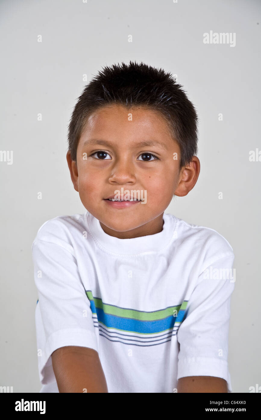 Cute young 6-7 year old Hispanic boy with two  front teeth missing. MR © Myrleen Pearson Stock Photo