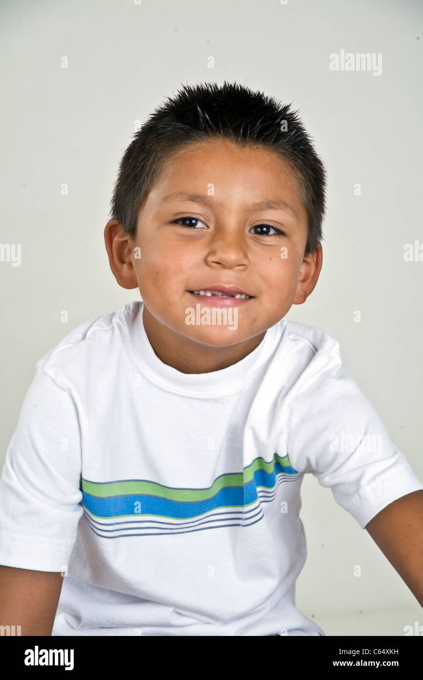 Cute happy young 6-7 year years old Hispanic boy with two missing front teeth. MR © Myrleen Pearson Stock Photo