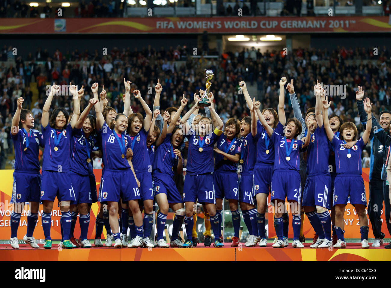 Japan captain Homare Sawa holds the World Cup trophy and celebrates with teammates after defeating the USA in the 2011 final. Stock Photo