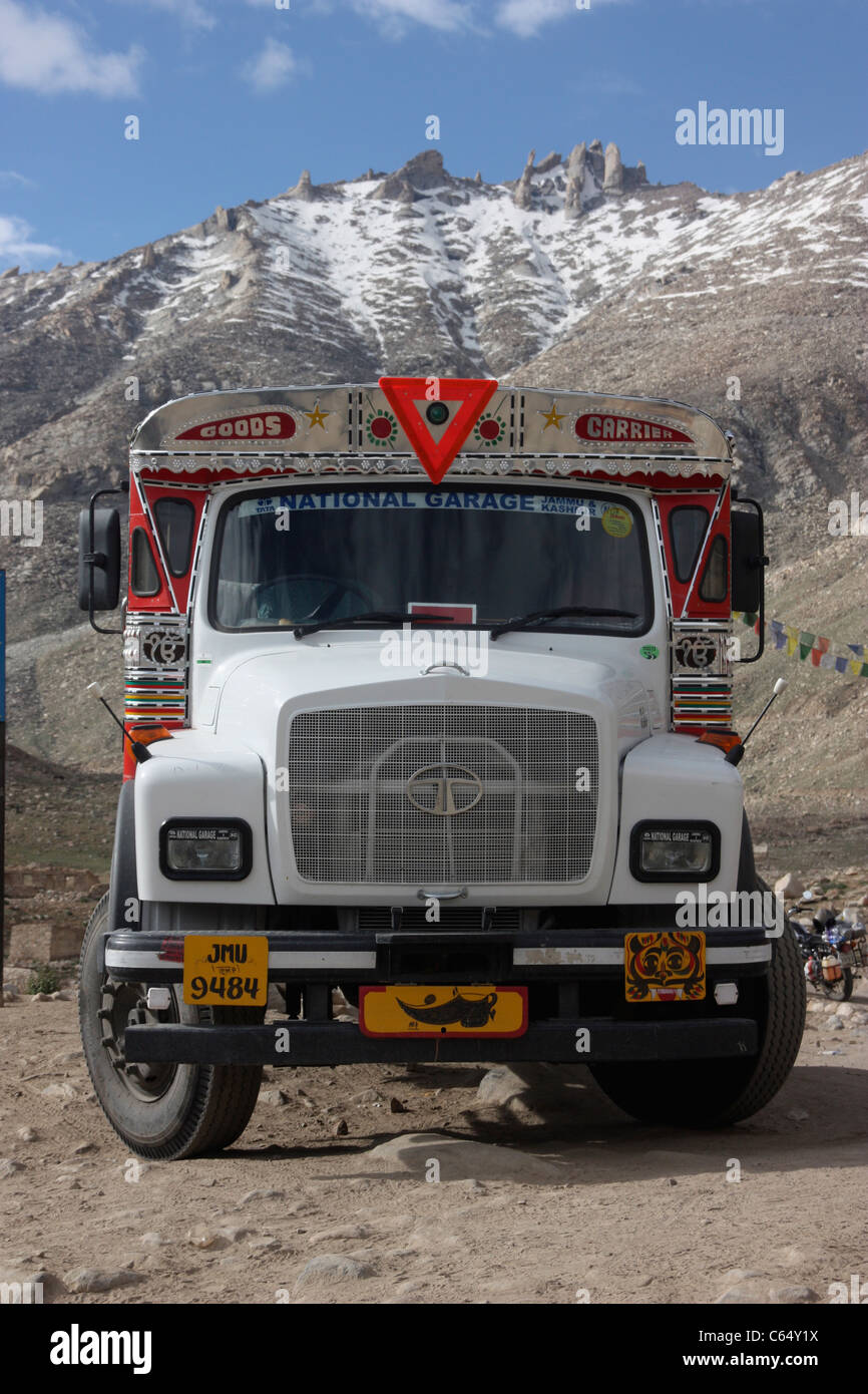 Decorated Tata goods carrier parked befo the snow capped on the highest