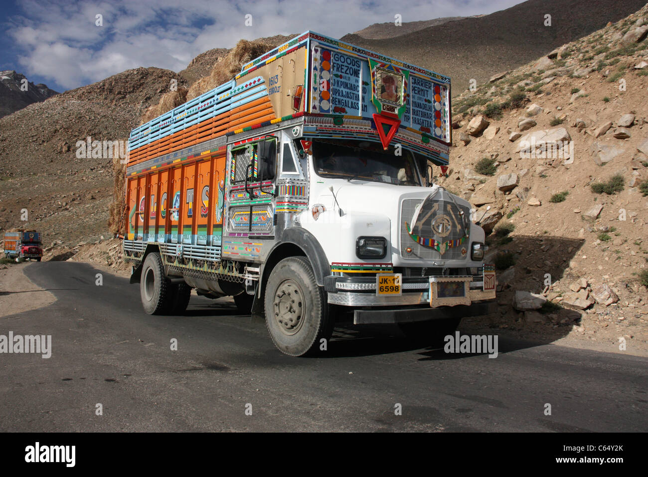 Decorated Tata goods carrier on mountain road in the Himalayas Ladakh northern India Stock Photo