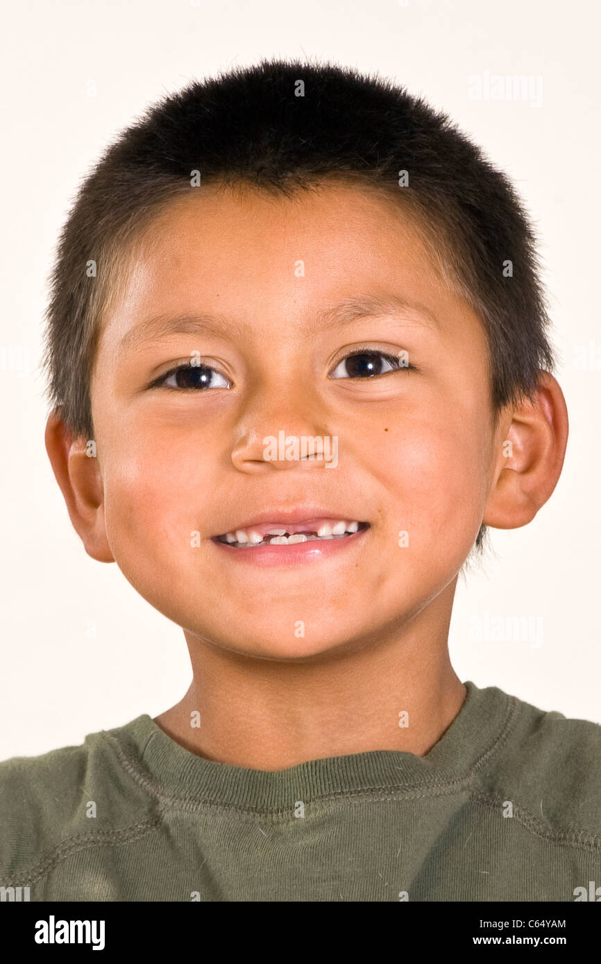 Cute young 6-7 year old Hispanic boy with two front teeth missing multi inter racial diversity racially diverse multicultural cultural interracial Stock Photo