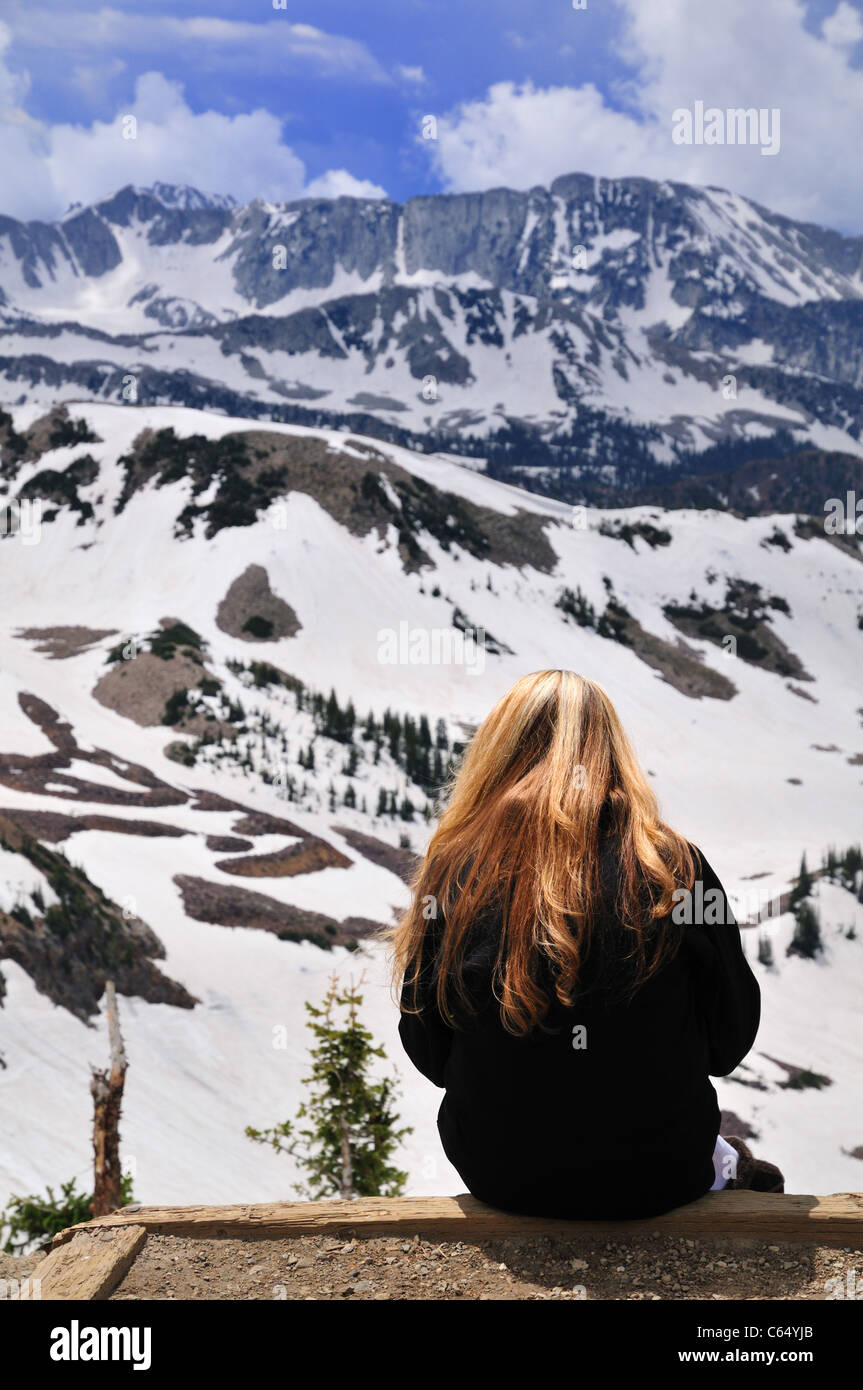 A young woman enjoys the mountain view from Hidden Peak in the Wasatch Mountains Stock Photo