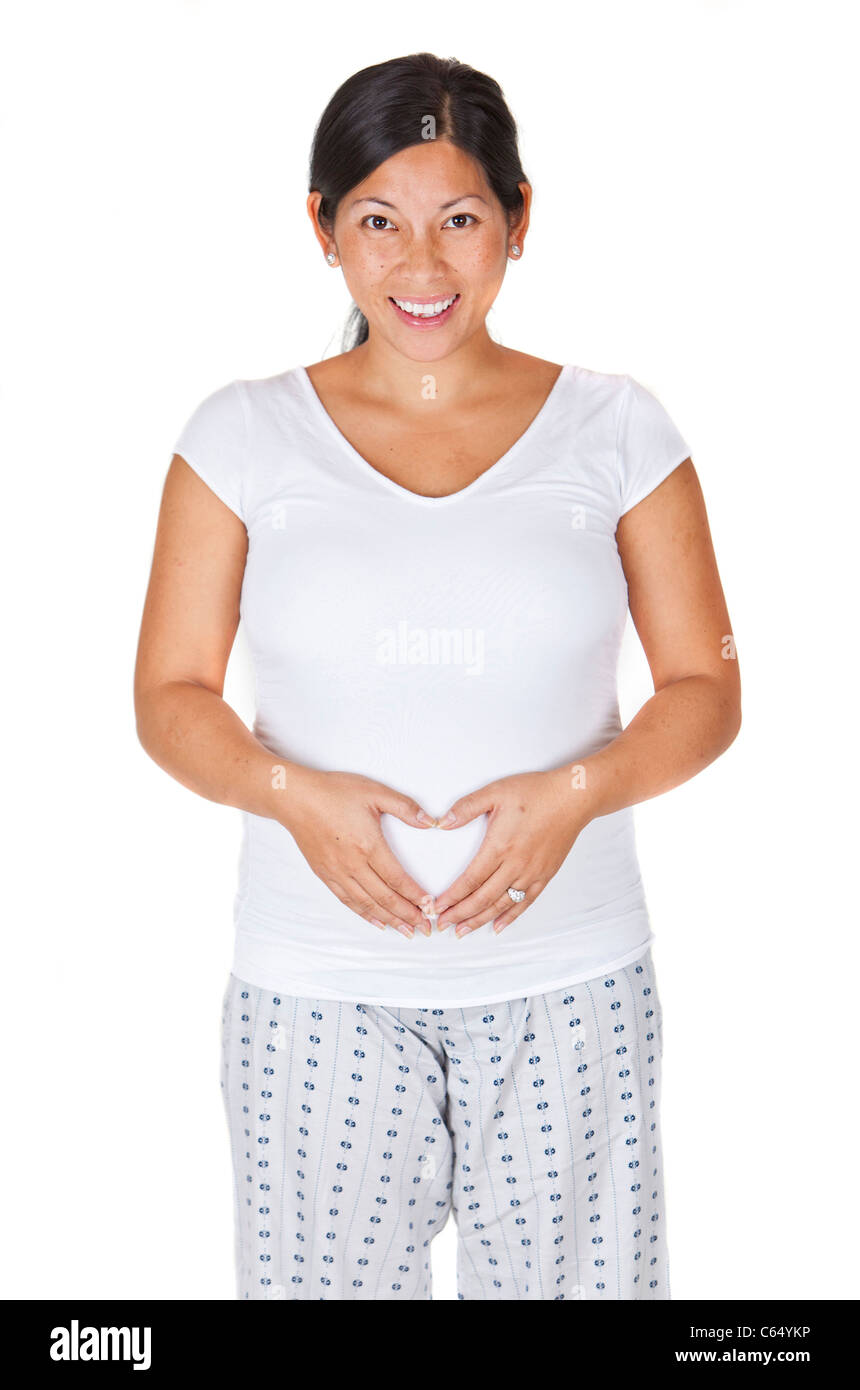 Pretty Asian pregnant woman making a heart with her hands Stock Photo