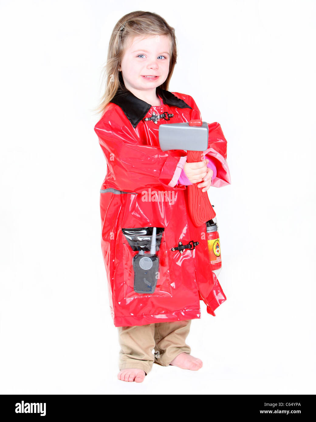 Toddler girl in firefighter costume with axe on white background Stock Photo