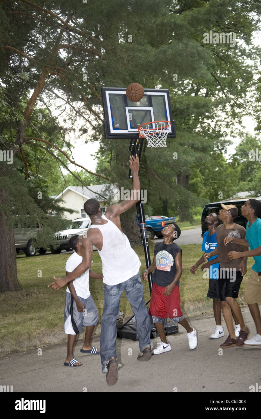 Boys play a pickup game of street basketball in the Brightmoor