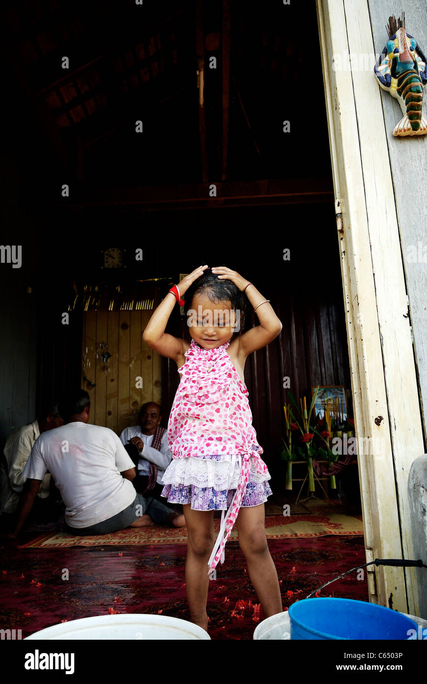 Girl, child, playing, taking a bath, Cambodian, home,sit, wall, Stock Photo