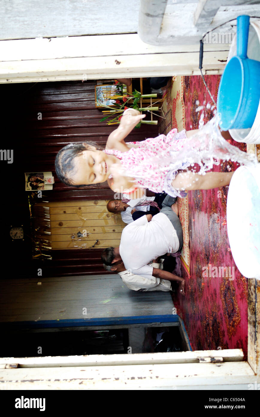 Girl, child, playing, taking a bath, Cambodian, home,sit, wall, Stock Photo