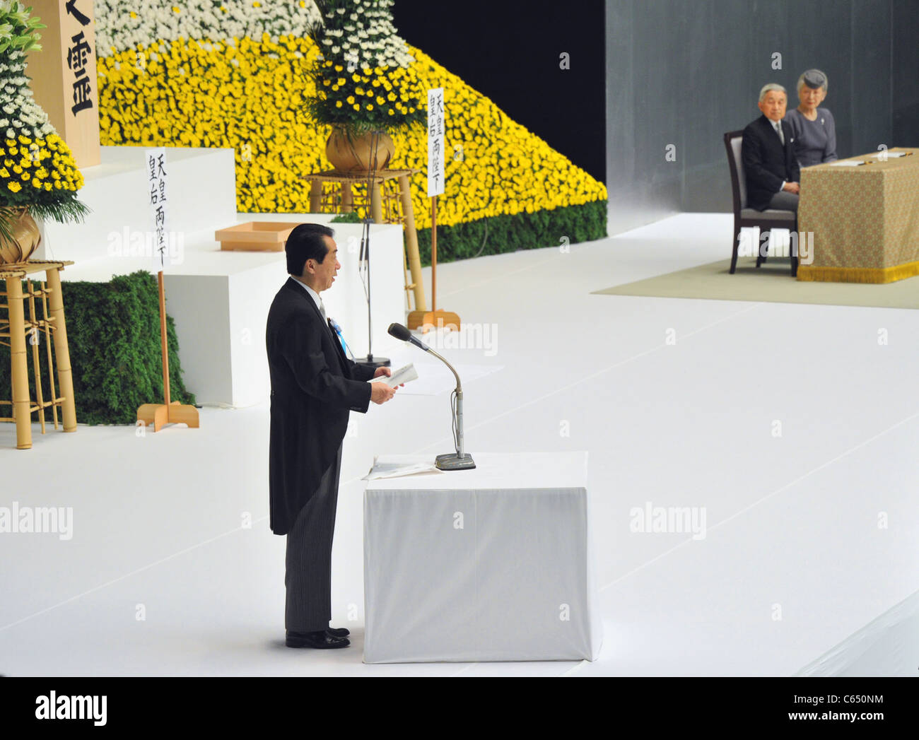 Japan's Prime Minister Naoto Kan walks the podium to delivers his statement during a government-sponsored memorial WWⅡ ceremony. Stock Photo