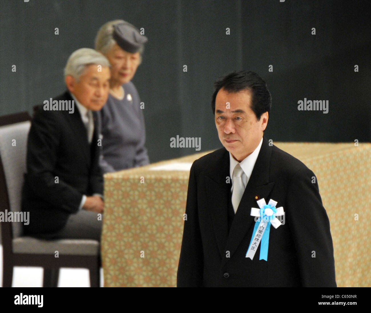 Japan's Prime Minister Naoto Kan walks the podium to delivers his statement during a government-sponsored memorial WWⅡ ceremony. Stock Photo