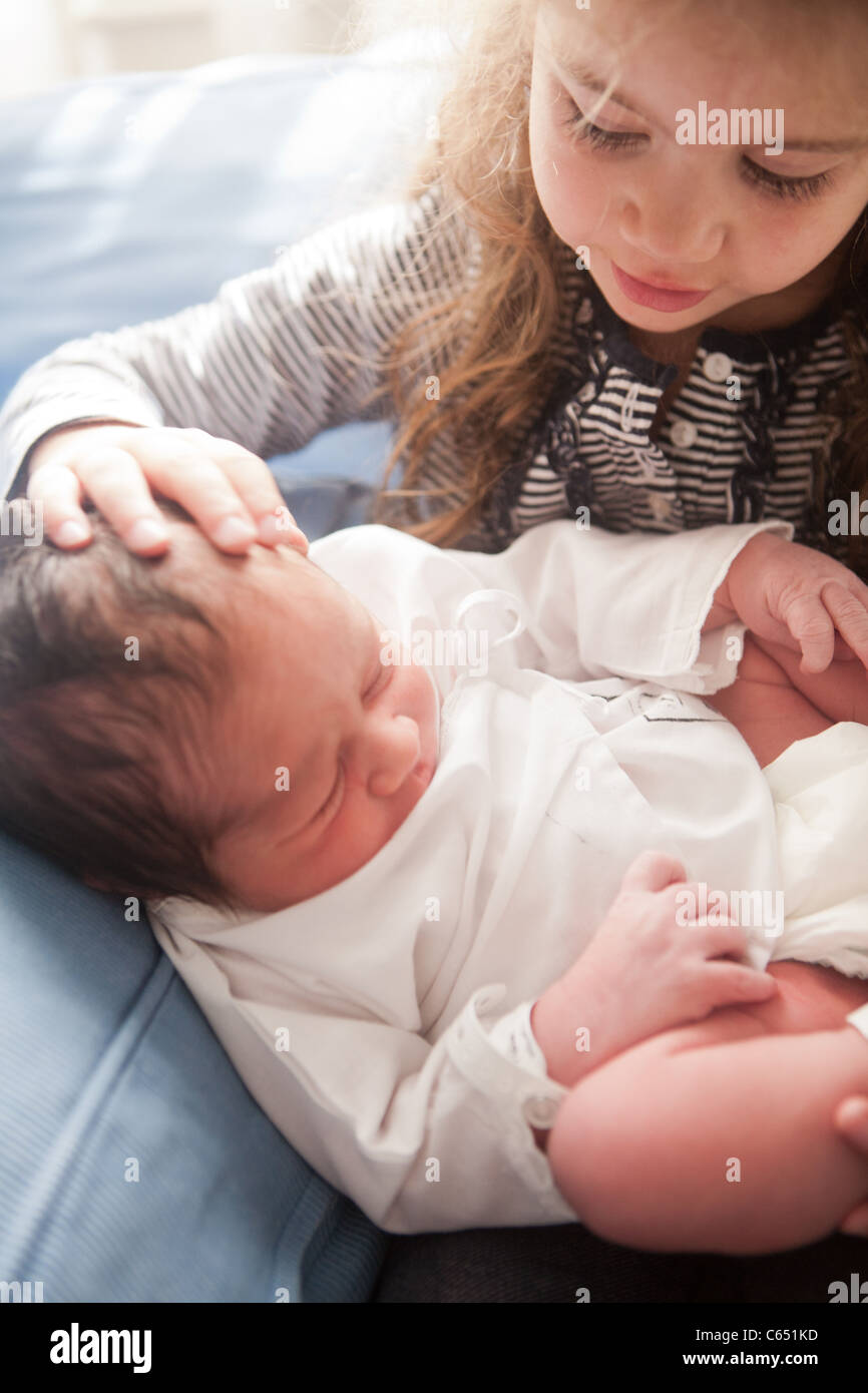 A Young Girl Caressing His Newborn Brother For The First Time In The Hospital Stock A Young Girl Caressing His Newborn Brother For The First Time In The Hospital Stock