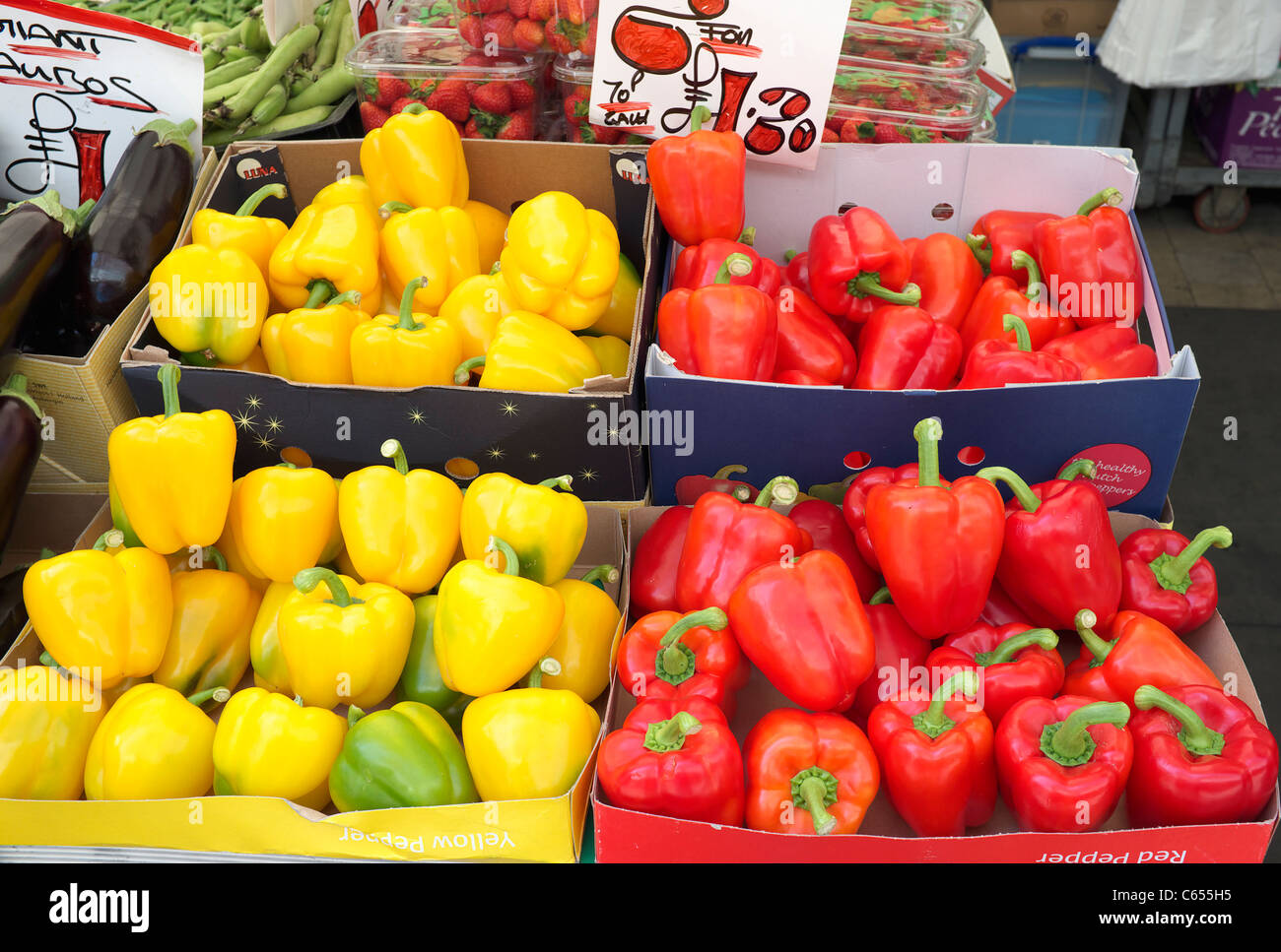 Red and yellow peppers displayed on a UK market stall Stock Photo - Alamy
