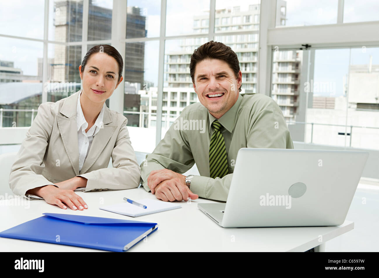 Businessman and businesswoman meeting in office with laptop Stock Photo ...