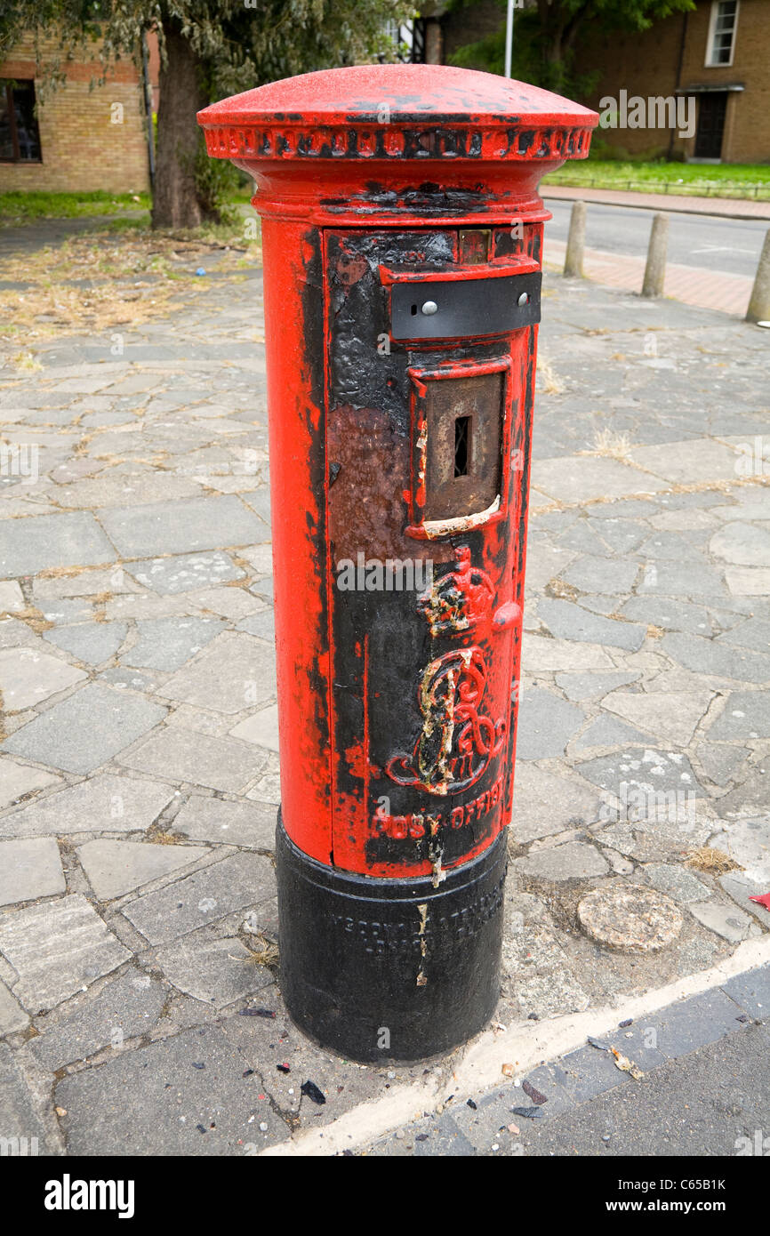 Vandalism / vandalised to a Type 'B' pillar box / post / letter box, which has been set fire to / burned / burnt. London. UK. Stock Photo