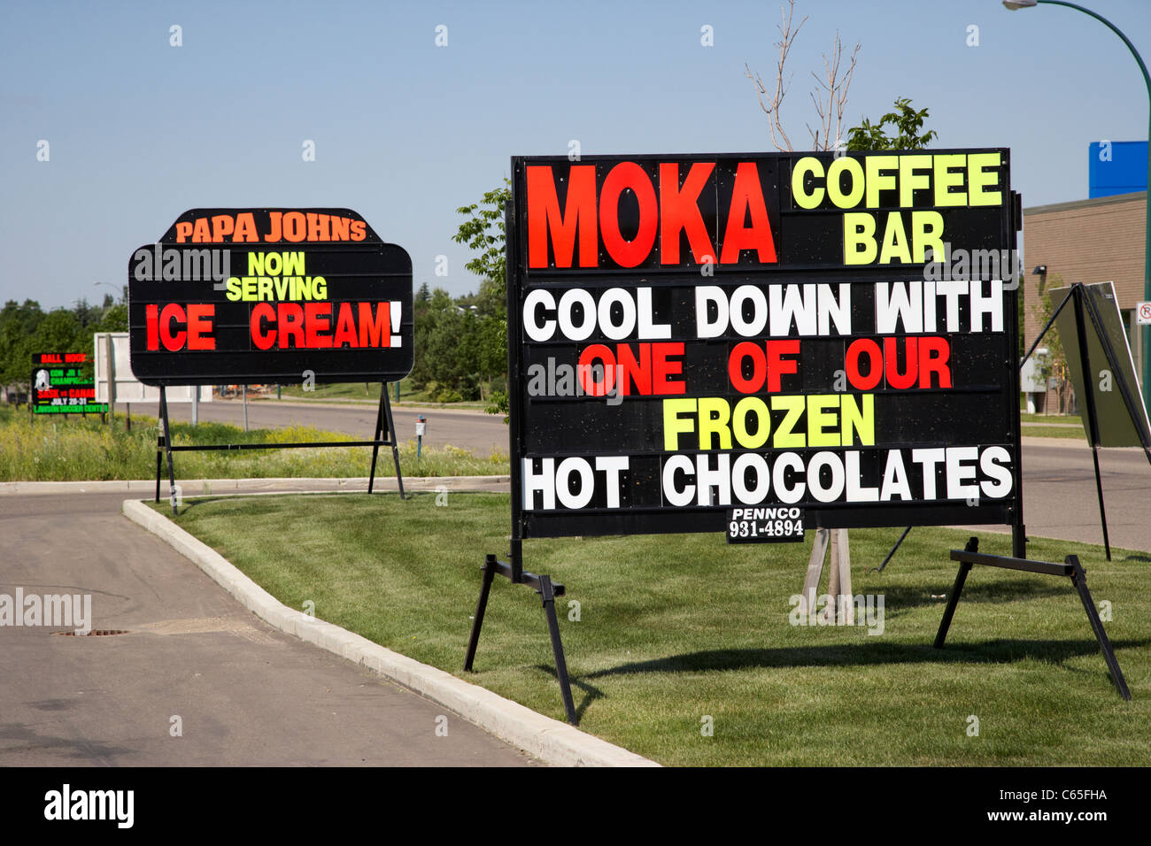 roadside luminous writing advertising signs in Saskatoon Saskatchewan Canada Stock Photo