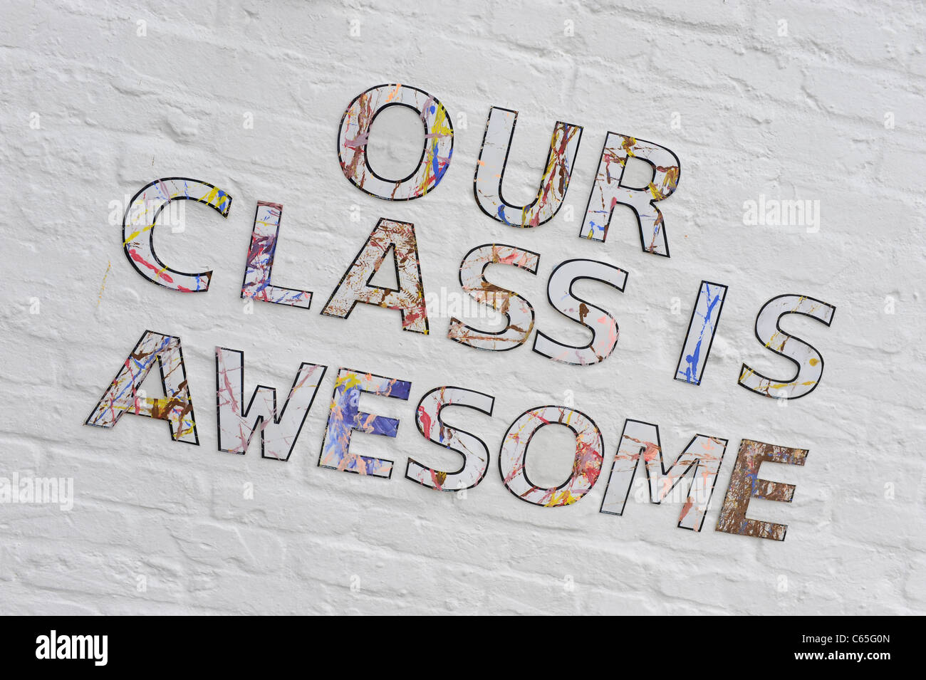 Writing on junior school wall 'Our Class Is Awesome' Stock Photo