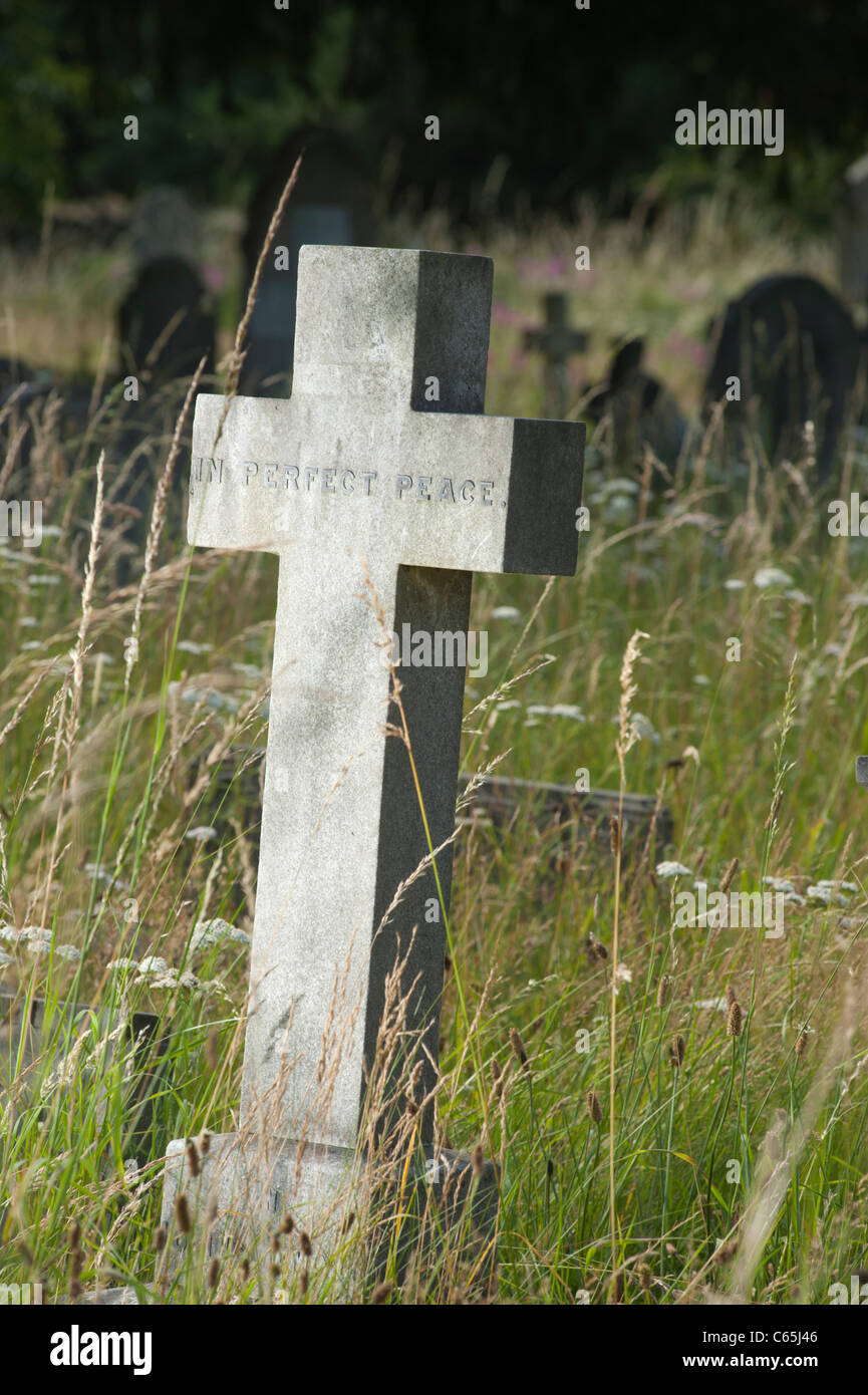 Stone Cross to mark a grave in a graveyard in West London, England, UK. The inscription reads