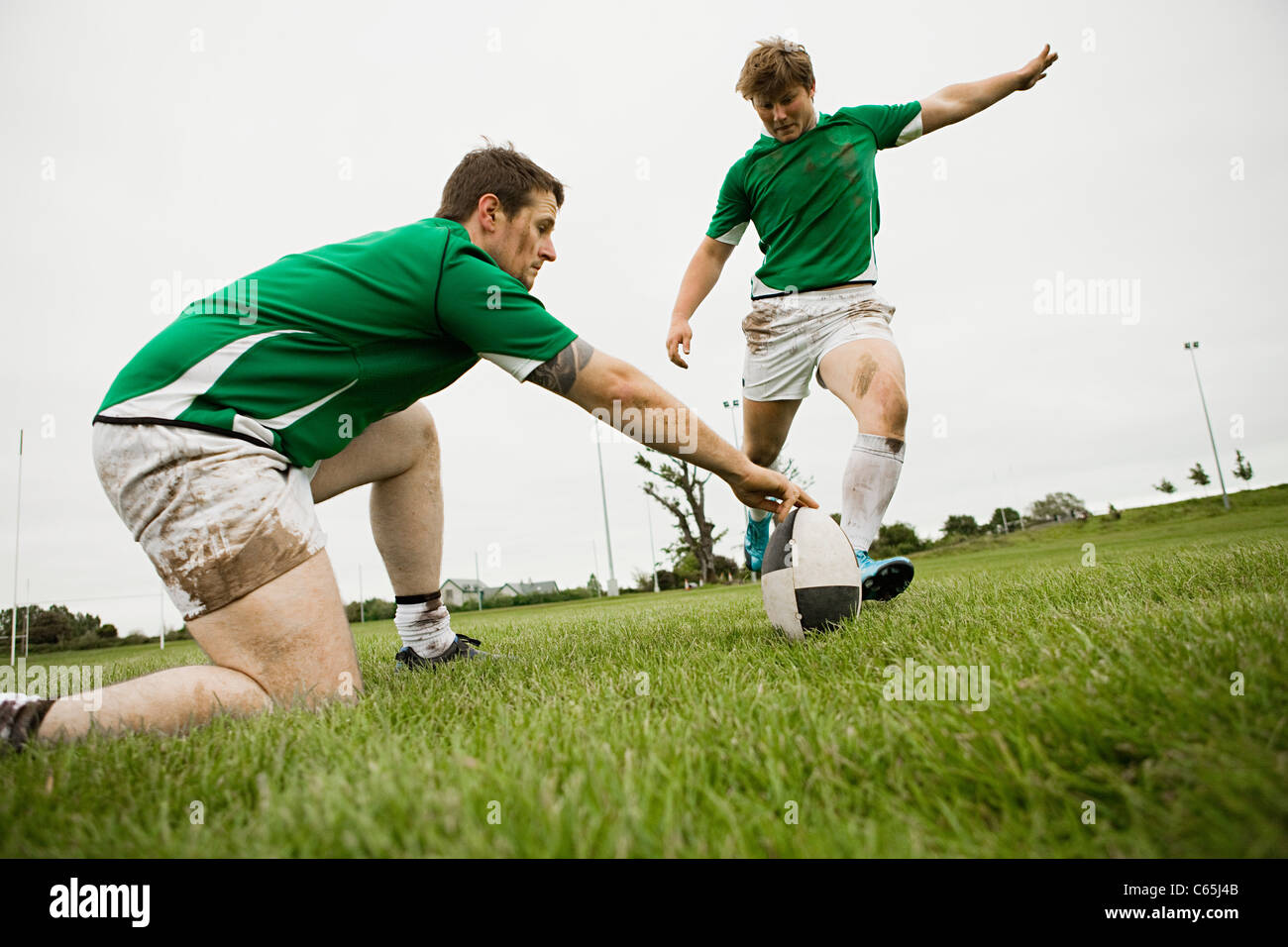Rugby player kicking ball Stock Photo