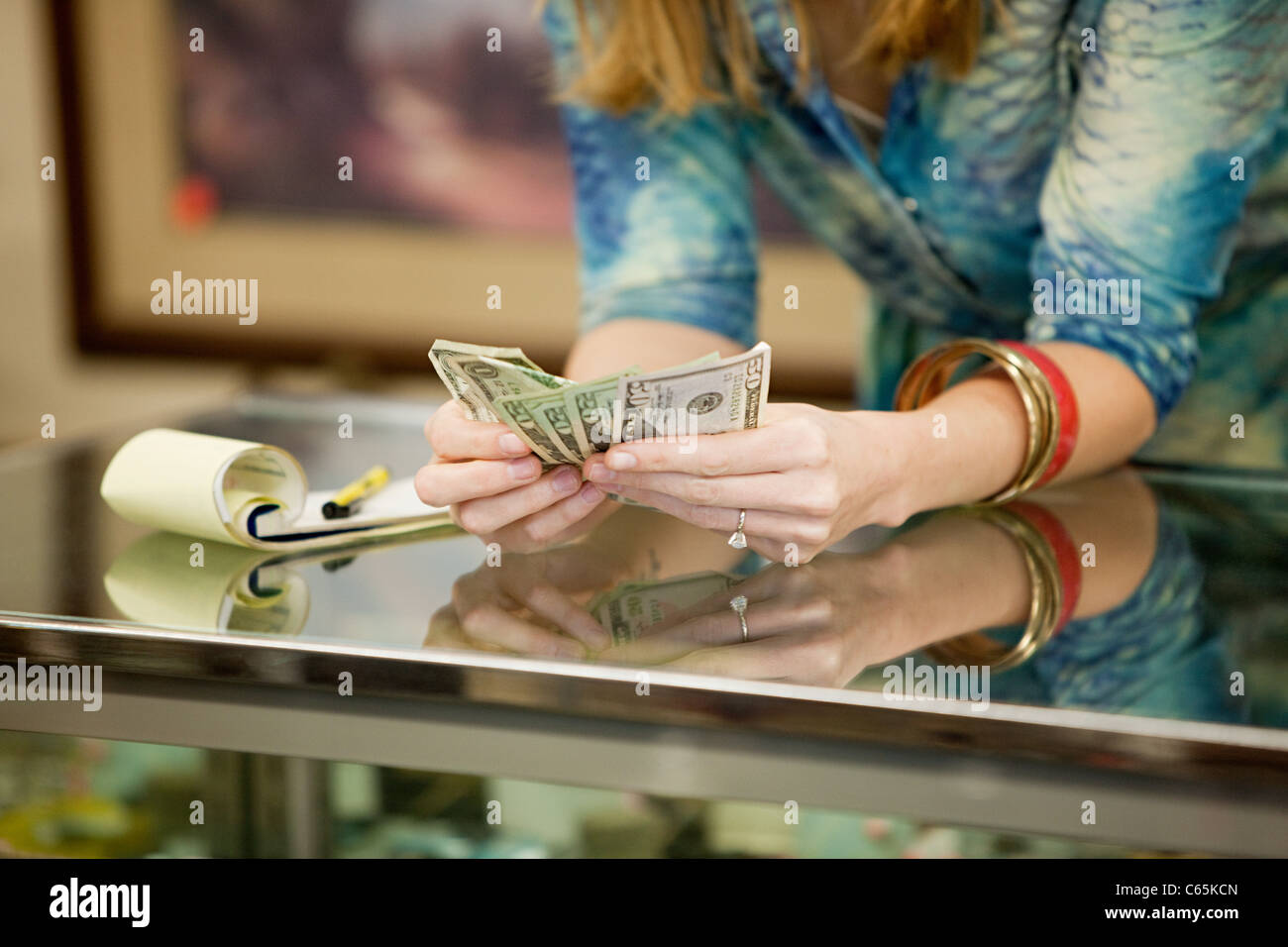 Shop keeper counting money in shop Stock Photo