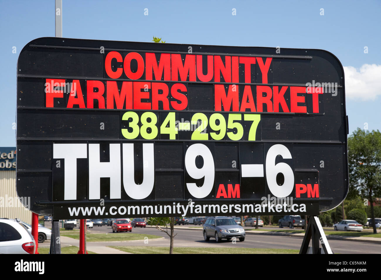 roadside luminous writing advertising sign for community farmers market in Saskatoon Saskatchewan Canada Stock Photo