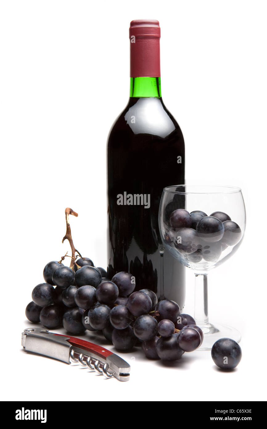 Bottle of red wine with grapes and corkscrew Stock Photo