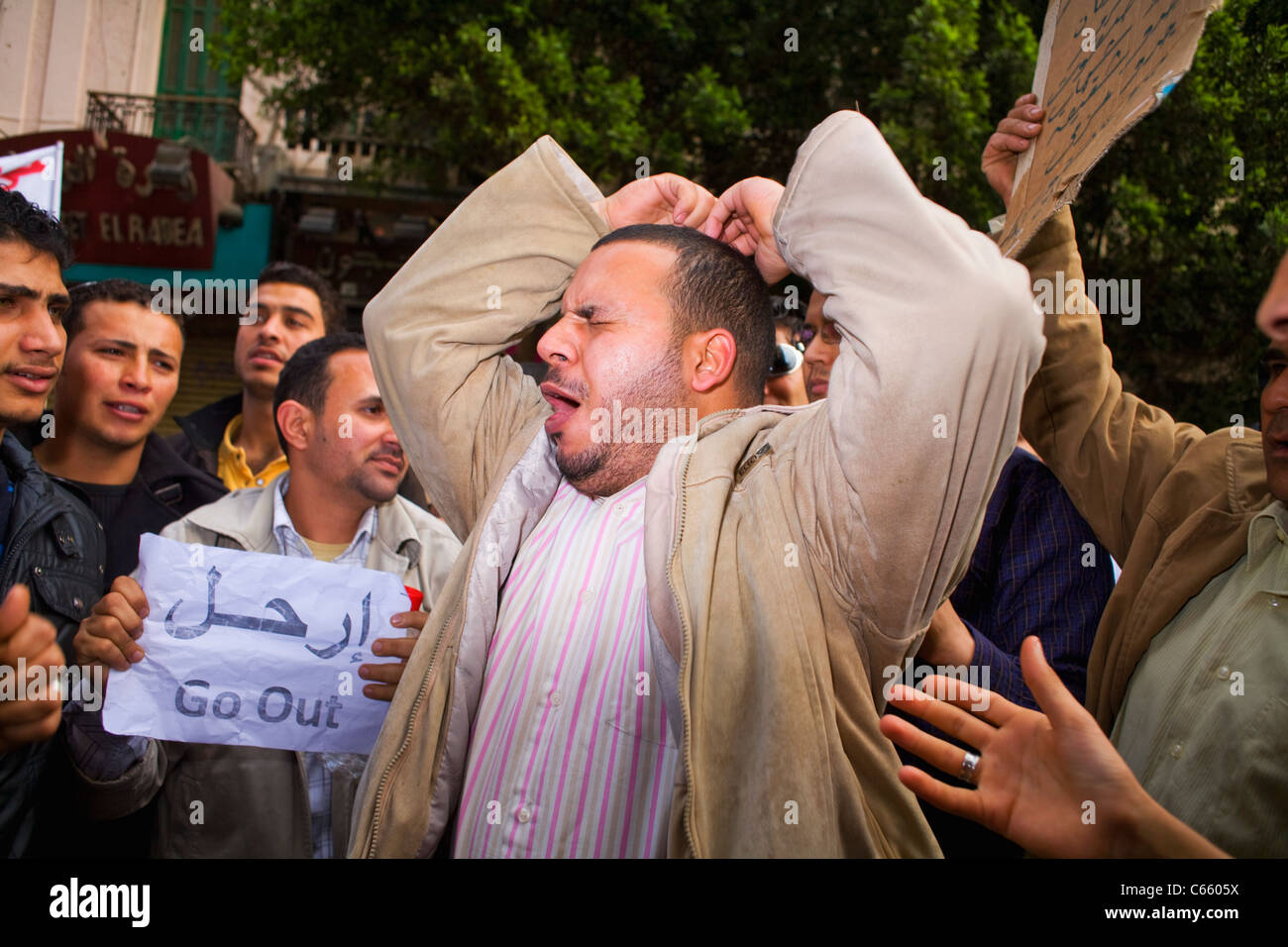 An anti-Mubarak protester gives a passionate speech at Tahrir Square in a group of other demonstrators on day 8 of the uprising Stock Photo