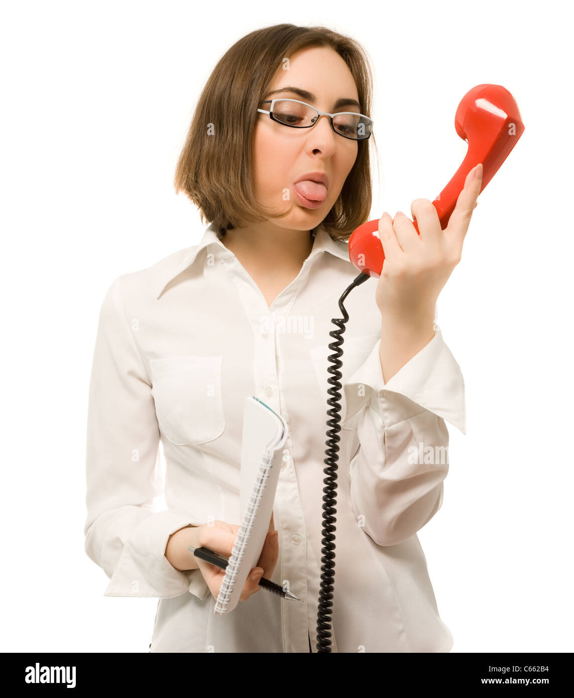 Picture of secretary showing tongue to the handset Stock Photo