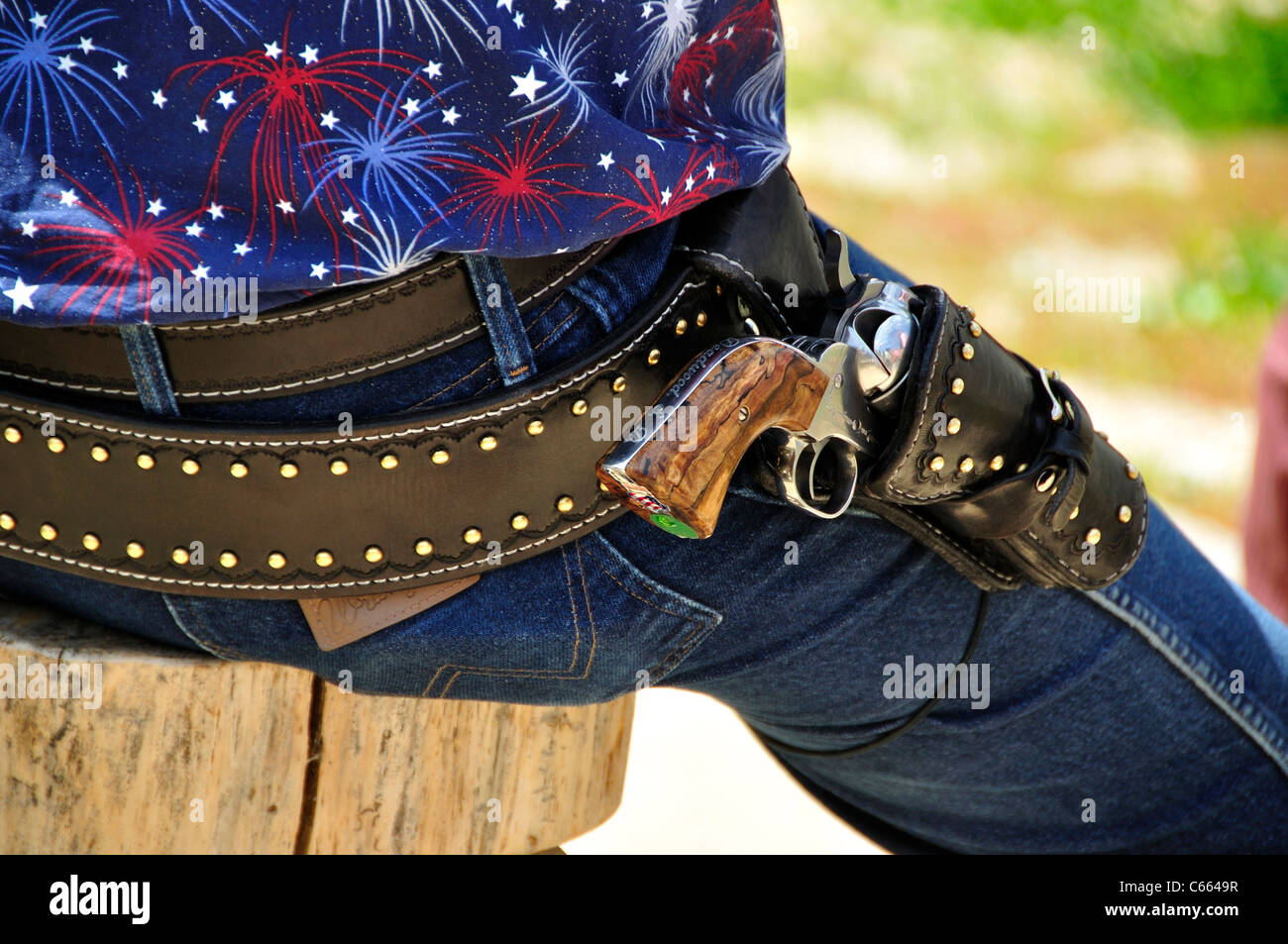 Traditional Coltstyle single action revolvers in holsters at a fast
