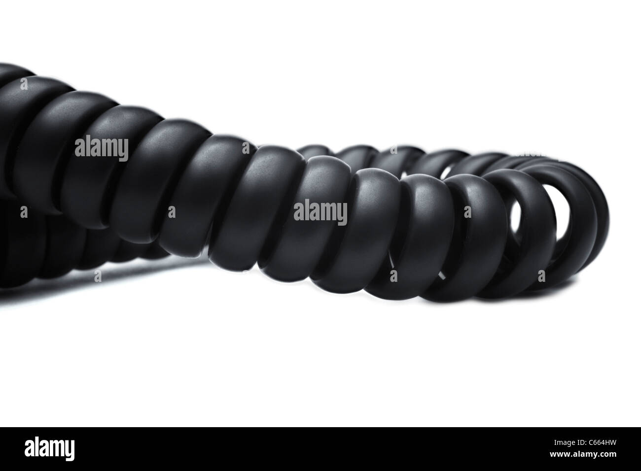 Twisted black telephone cord on white background closeup Stock Photo
