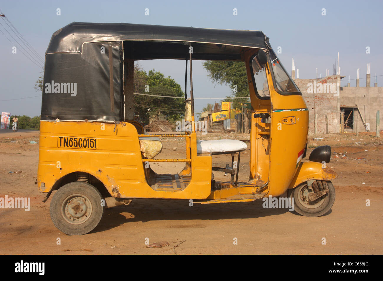 Three wheeler auto rickshaw taxi stands empty on dusty Tamil street streets in Tamil Nadu, India Stock Photo