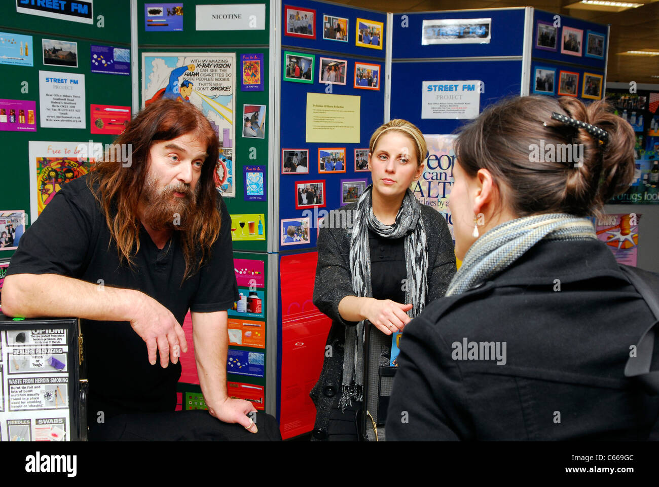 Visitor to a stall at a drug education event asking for information, Hertfordshire, UK. Stock Photo