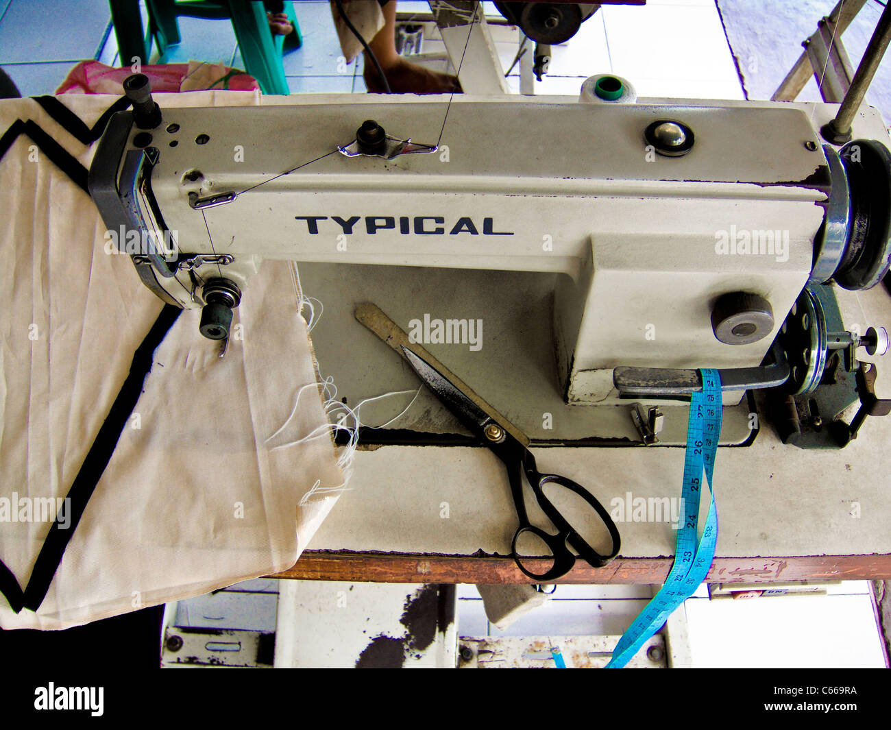 Well used sewing machine and tailors scissors in roadside tailors shop